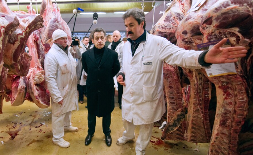 French President Nicolas Sarkozy listens to a butcher during a visit to the butchery pavilion at the Rungis international food market, near Paris, in February. 