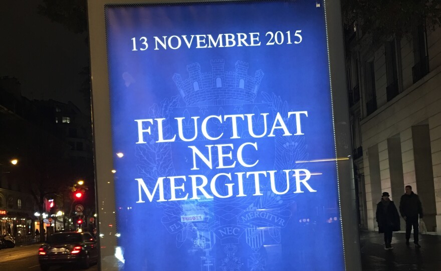 A Paris billboard sports an oft-repeated motto in response to the terror attacks, "fluctuat nec mergitur," or "tossed but not sunk."