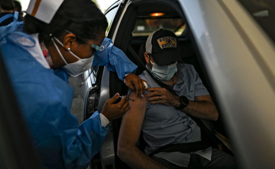 A man receives a dose of the AstraZeneca COVID-19 vaccine at the Romel Fernadez Stadium in Panama City, Panama.