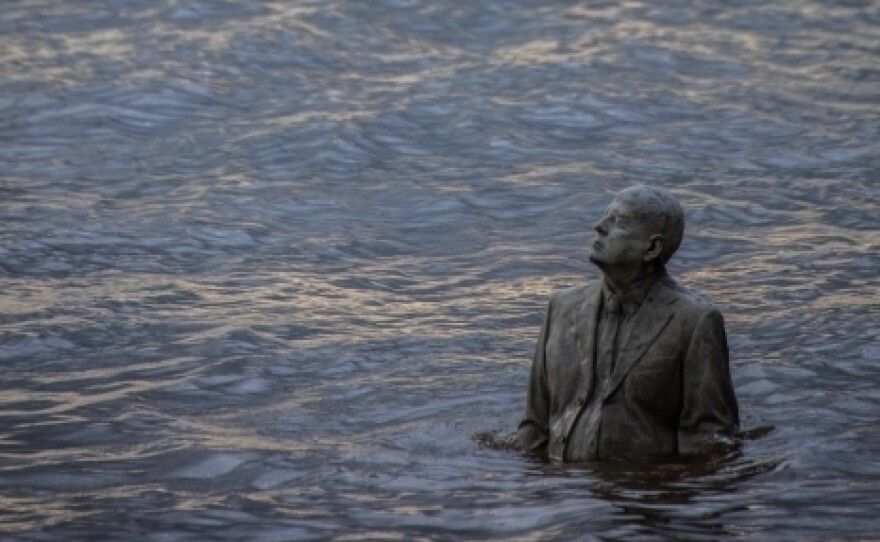 One of the suited men at the heart of Taylor's The Rising Tide — within feet of being subsumed.