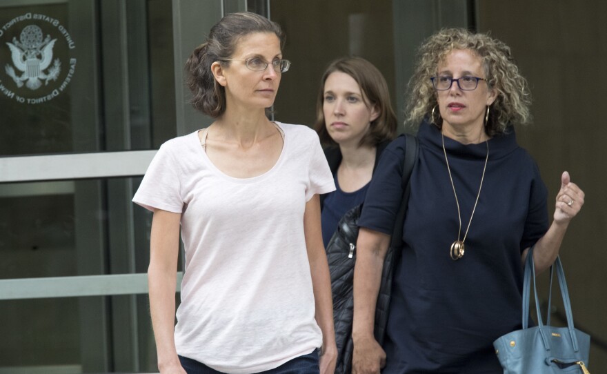 Clare Bronfman (left) leaves federal court in New York on Tuesday after being charged in connection with NXIVM. An heiress to the Seagram's liquor fortune, Bronfman was released on a $100 million bond.