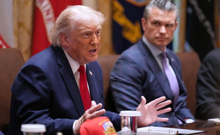 President Donald Trump speaks during a Cabinet meeting at the White House, Wednesday, May 27, 2026, in Washington, as Secretary of Defense Pete Hegseth, looks on.