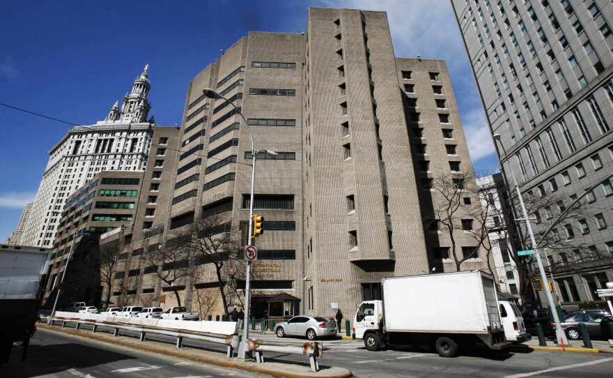 The warden of the Metropolitan Correctional Center in New York City has been reassigned and two others suspended pending official investigations, the Justice Department said.