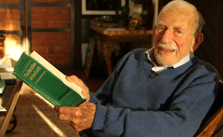 Walter Munk holds a copy of The Rotation of the Earth, a book he co-wrote in 1960, March 9, 2016.
