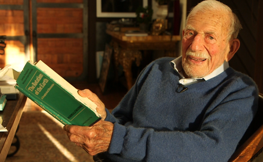 Walter Munk holds a copy of The Rotation of the Earth, a book he co-wrote in 1960, March 9, 2016. 