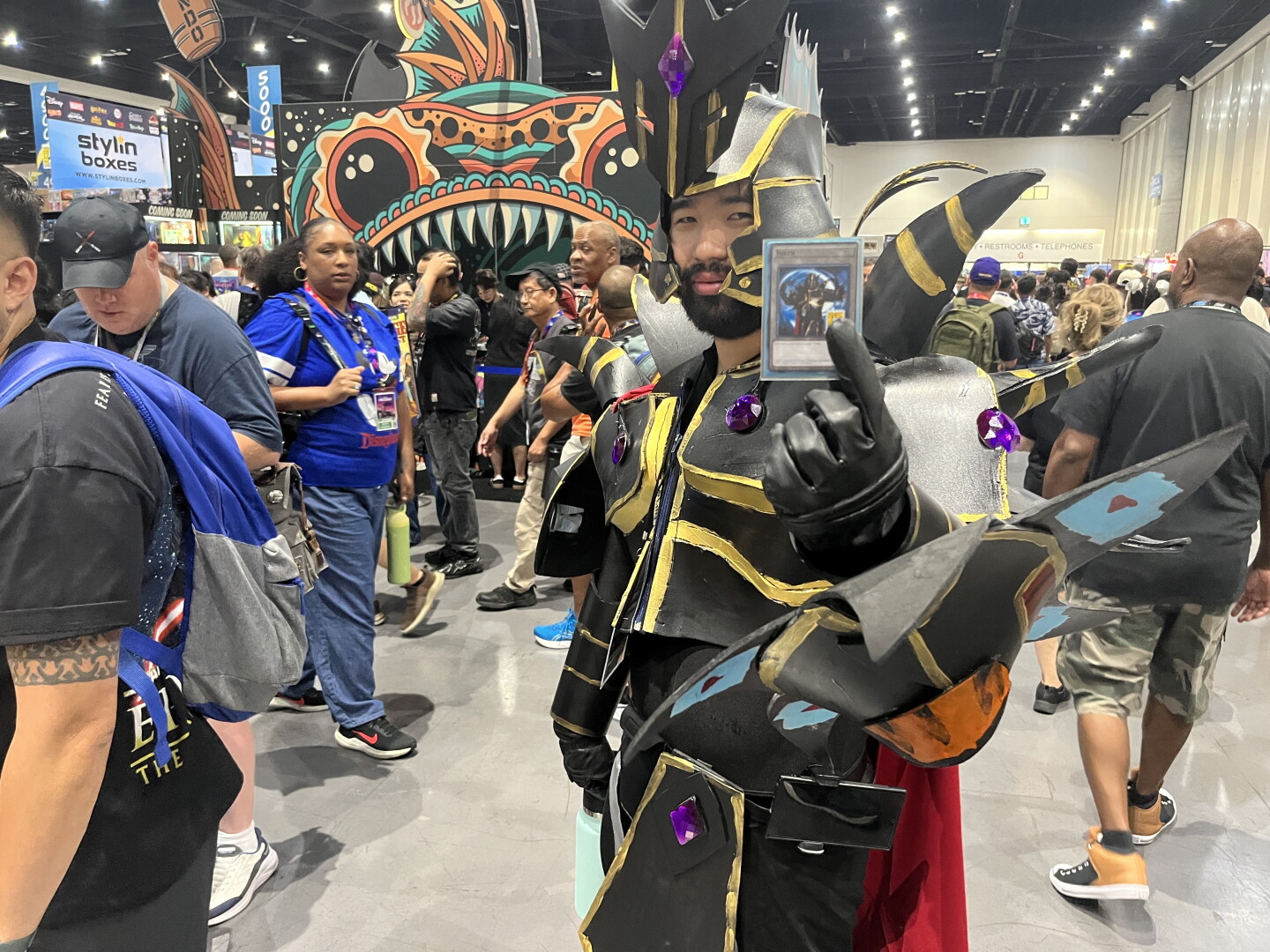A cosplayer dressed as the Supreme King from "Yu-Gi-Oh! GX" holds a Duel Monsters card at Comic-Con, July, 24, 2026.