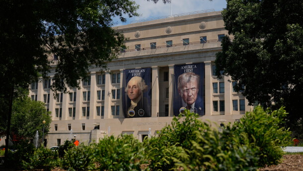 Banners of former President George Washington and President Donald Trump hang above an entrance to the Department of the Interior, Thursday, June 25, 2026, in Washington.