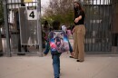 Kindergartener Angel Hernandez leaves after the first day of in-person learning at Maurice Sendak Elementary School in Los Angeles, Tuesday, April 13, 2021.