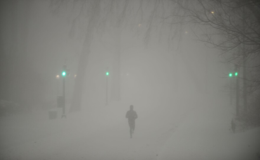 A lone jogger moves through heavy snow fall and strong wind gusts in Central Park on January 23 in New York City.