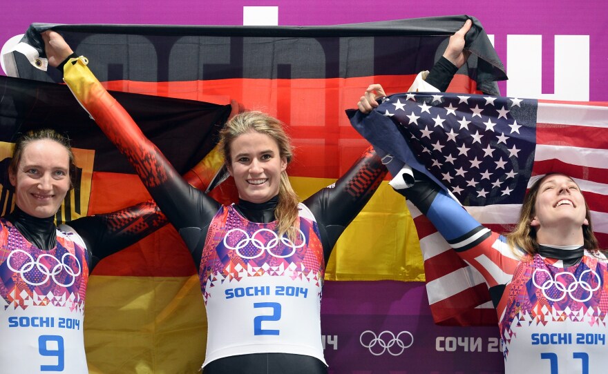 Erin Hamlin (right) exults after winning the first-ever U.S. medal in the singles luge Tuesday. She stands with German gold medalist Natalie Geisenberger (center) and silver medalist Tatjana Huefner.