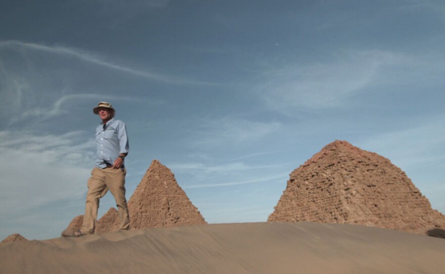 Archeologist Tim Kendall walks through the sand dunes near Taharqa’s pyramid in Nuri.