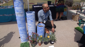 San Diego land use planner Frank Santana kneels in front of a display that shows how much water different plants need, April 19, 2016 