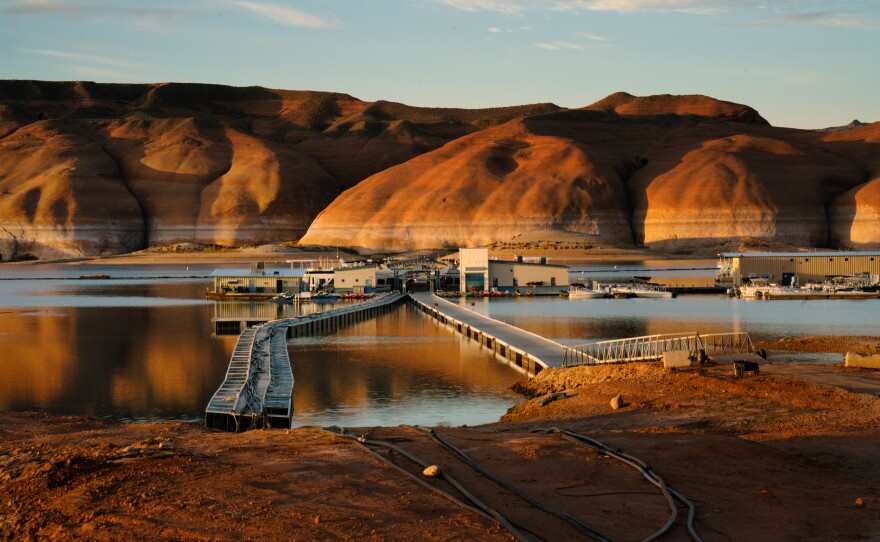 Dawn at Bullfrog Marina on Lake Powell in Utah. Waterlines on the rocks in the background show how far the water has dropped in recent years.