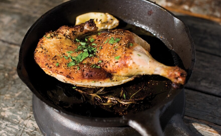 Jay Bentley's technique for Cast Iron Roasted Half Chicken involves cooking a whole chicken between two very hot and heavy pans.