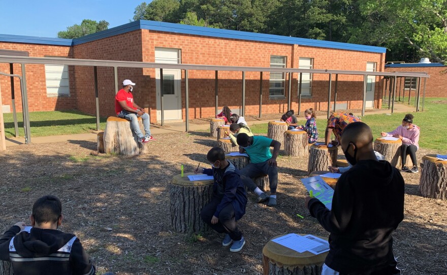 Students at Foust Elementary School in Greensboro, North Carolina gather in an outdoor classroom.