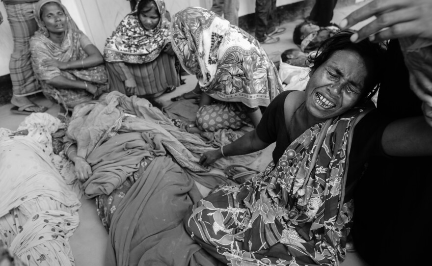 A woman mourns over a relative who died in the Rana Plaza building collapse, in Savar, Bangladesh, April 24, 2013.