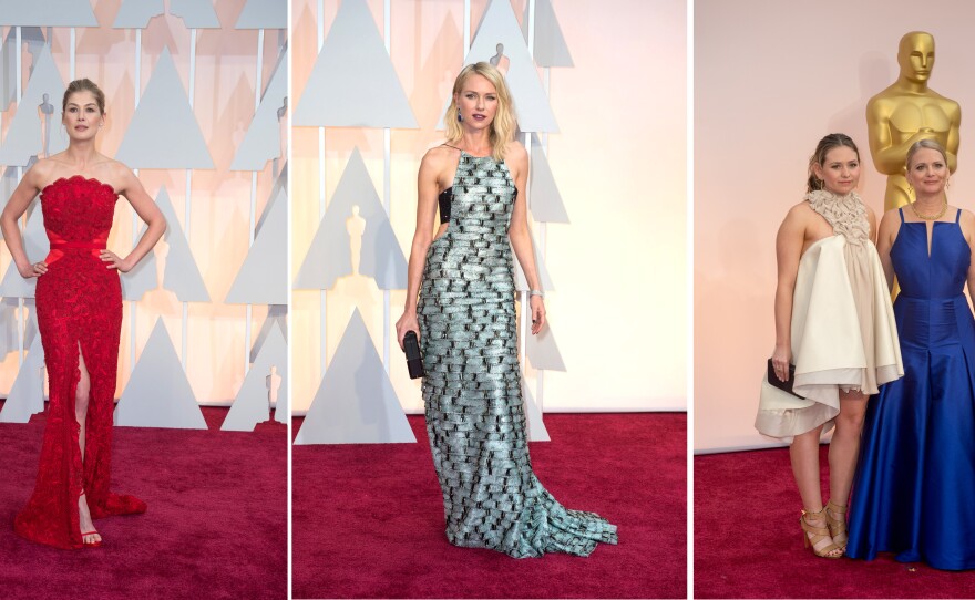 The good, the bad and the ugly at the 87th annual Academy Awards, Feb. 22, 2015. The good: Best Actress nominee Rosamund Pike, far left, looked stunning in one of the few dresses of color. The bad: Actress Naomi Watts, middle, looked like she was wearing a wall of silver bricks, and the ugly: "Boyhood's" producer Cathleen Sutherland and guest, far right, were a fashion nightmare. 