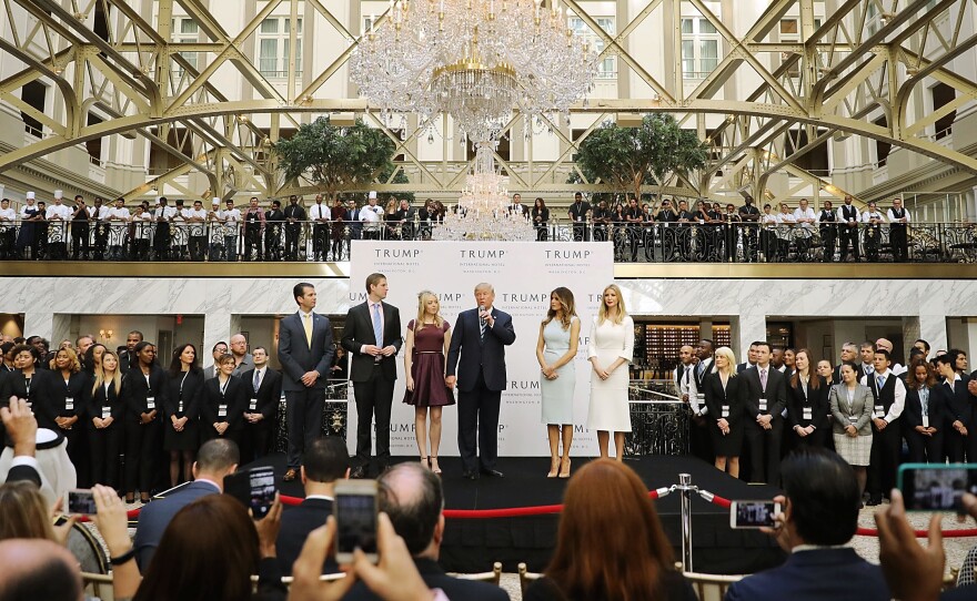 Then Republican presidential candidate Donald Trump (center) and his family prepare to cut the ribbon at the new Trump International Hotel on Oct. 26, 2016, in Washington, D.C.