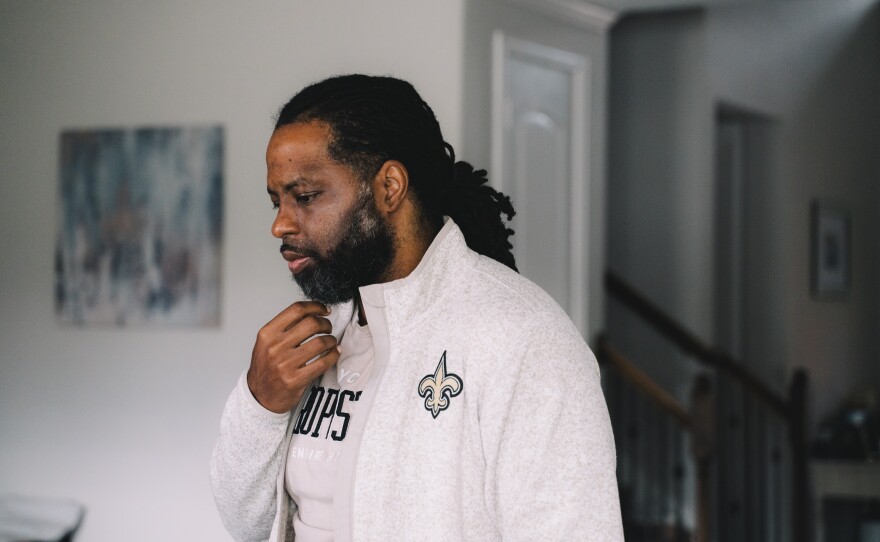 Edmund Garcia, an Iraq war veteran, listens to a phone call from the VA through his earpiece concerning his financial situation about his home.