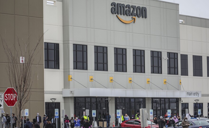 Workers at Amazon's fulfillment center in Staten Island, N.Y., gather outside to protest work conditions on March 30. More protests are being staged around the country this week.