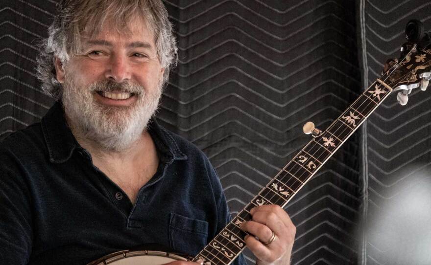 Bela Fleck is shown playing the banjo.