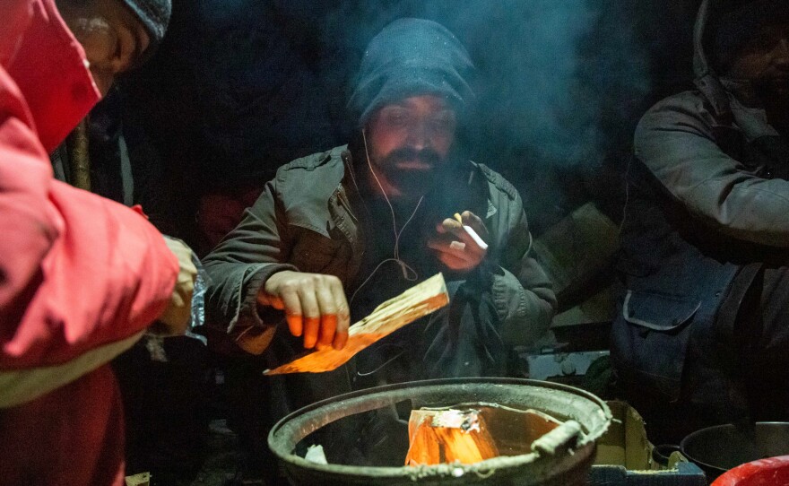 Pakistani migrant Abdel Khadeer, 31, starts a fire in an improvised shelter high in the woods outside the Bosnian town of Bihac, near the Croatian border. Winter temperatures in the area drop below freezing at night.