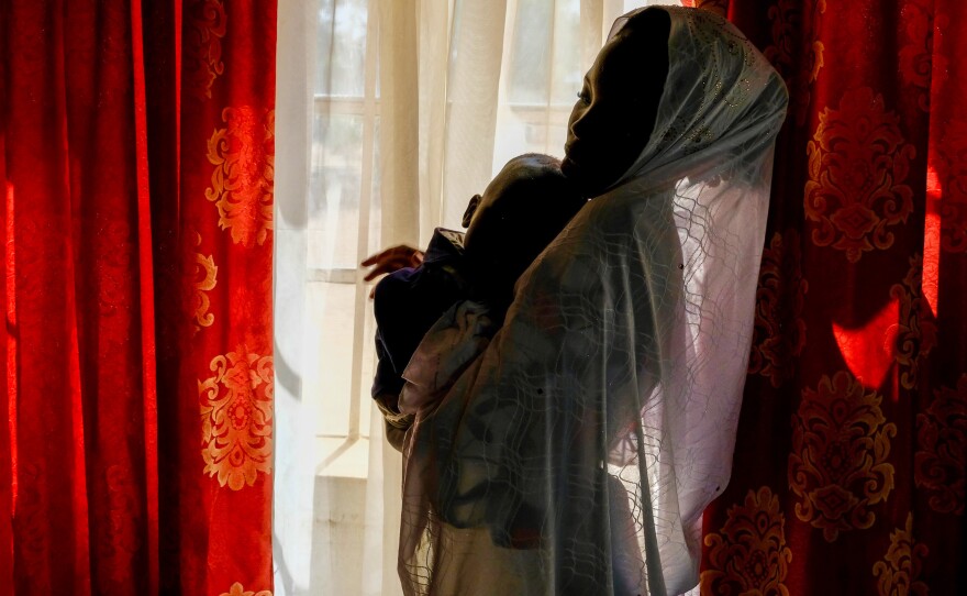Salamatu Umar, who was forced to marry a Boko Haram fighter, holds son Usman Abubakar.