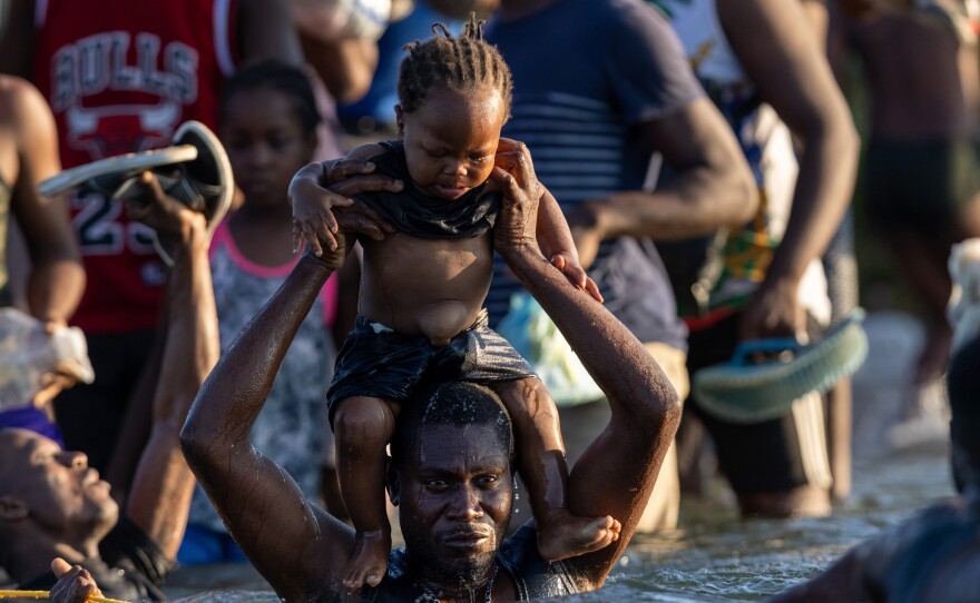 Haitians cross the Rio Grande back into Mexico from Del Rio on Monday. As U.S. authorities began deporting migrants back to Haiti, thousands more waited in a camp in Del Rio and others crossed the river back into Mexico to avoid deportation.