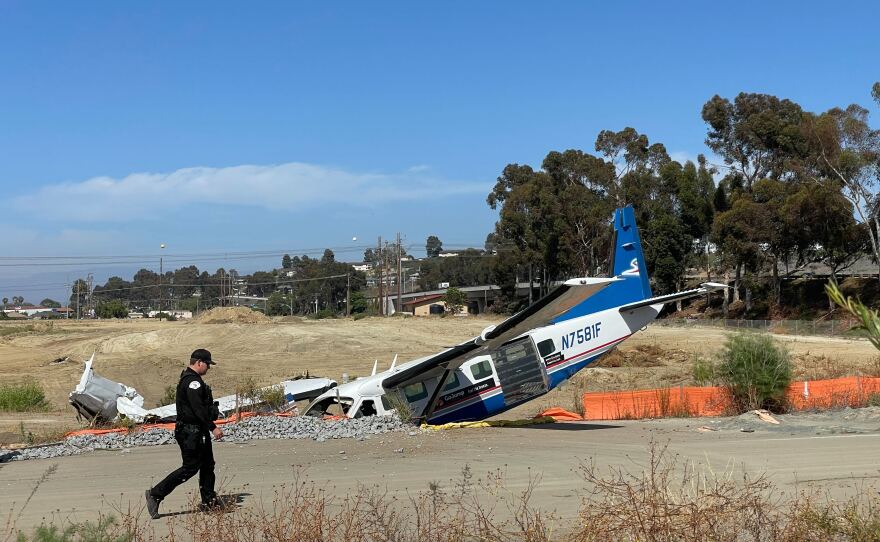 An Oceanside police officer near the wreckage of the GoJump Oceanside aircraft, June 3, 2022.