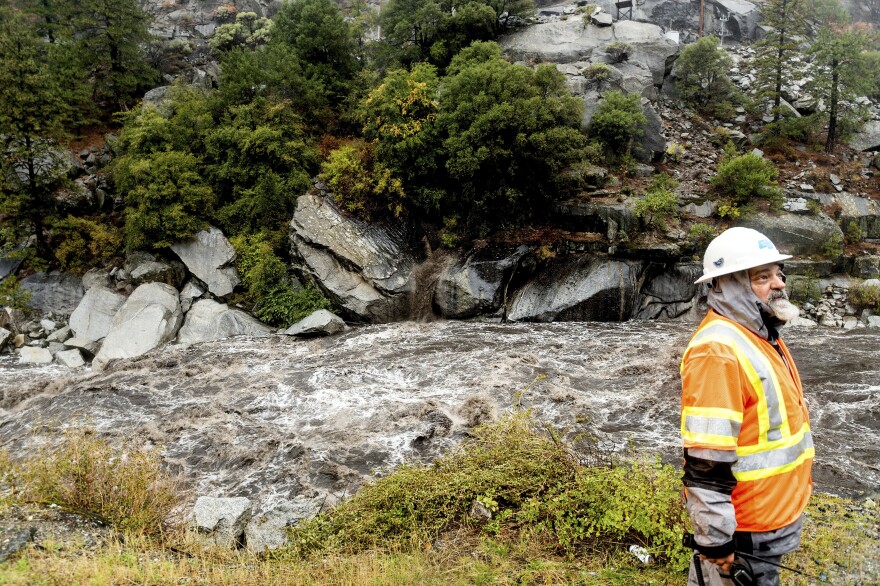 Caltrans maintenance supervisor Matt Martin surveys a landslide covering Highway 70 in the Dixie Fire zone on Sunday, Oct. 24, 2021, in Plumas County, Calif. Heavy rains blanketing Northern California created slide and flood hazards in land scorched during last summer's wildfires.