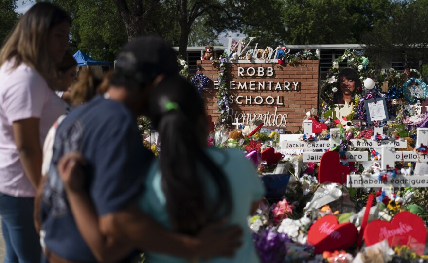 People visit a memorial at Robb Elementary School in Uvalde, Texas, on June 2, 2022, to pay their respects to the victims killed in a school shooting.