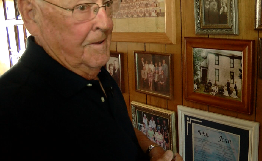 John Rawlings, 90, looks at family photos in his San Diego home, April 21, 2016.