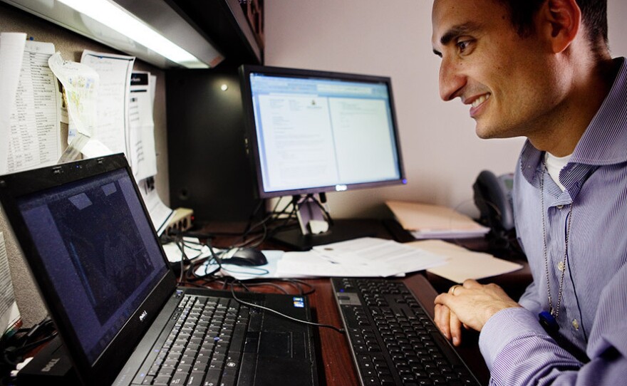 Dr. Ray Dorsey video chats with a patient in New York State from his office at Johns Hopkins Medical Center in Baltimore in 2011.