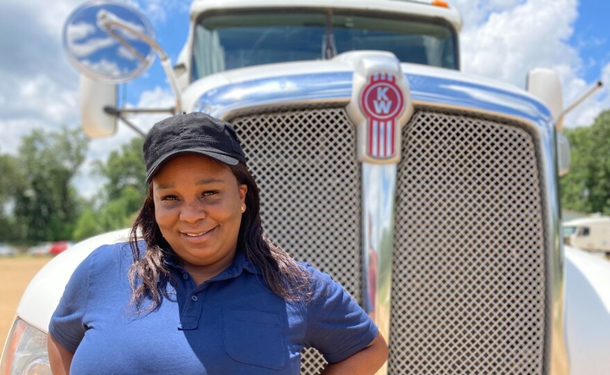 Pamela Williams, a driving instructor with DSC Training Academy, stands in front of one of the academy's trucks on June 29. Williams has been driving for seven years and enjoys seeing the country from the road.
