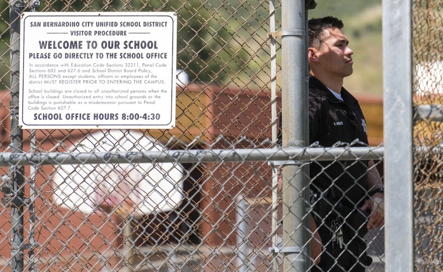 A police officer stands guard outside North Park School after a fatal shooting at the elementary school in San Bernardino, Calif., April 10, 2017.