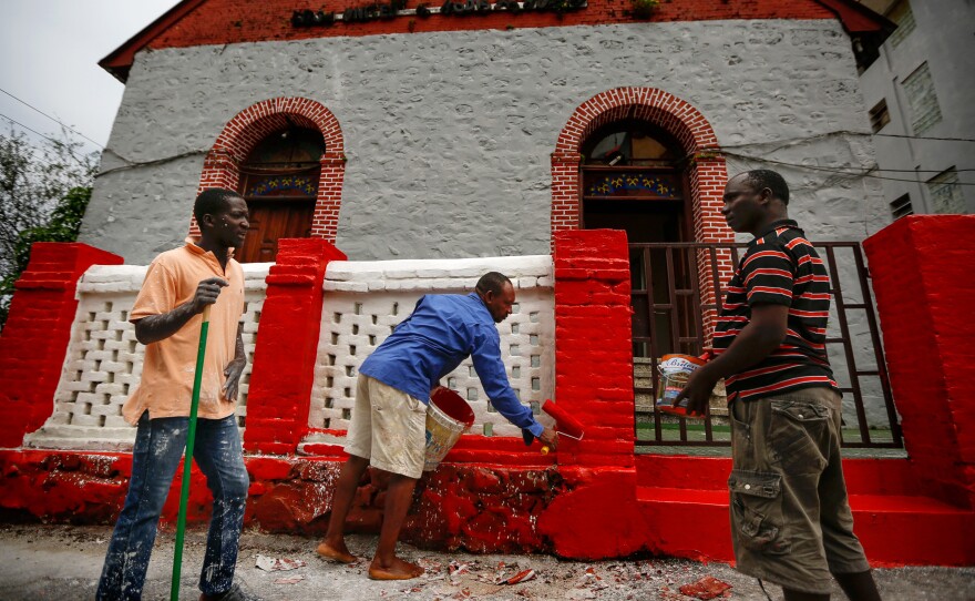 The Liberian government demands a fresh coat of paint on every building before Christmas. Painters spruce up the United Methodist Church in Monrovia.