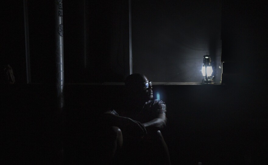 Jaime Degraff sits outside on Sept. 23, 2017, as he waits for the Puerto Rican electrical grid to be fixed after Hurricane Maria. The island is still struggling with power outages.
