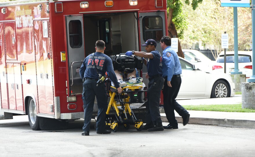 A victim is taken into Broward Health Trauma Center in Fort Lauderdale, Fla., on Friday following a shooting at the Fort Lauderdale-Hollywood International Airport.