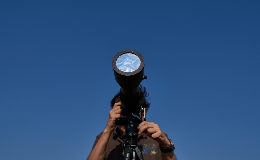 Javier Sanchez, a member of the "Los Taraos" astrophotography group, sets up his photo camera to shoot a total solar eclipse in Berlanga de Duero, central Spain.
