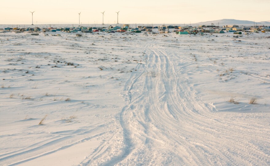 ATV and snow machine tracks lead from the airstrip to the village in Toksook Bay. Census Bureau officials crossed the tundra by plane to reach the fishing village along the Bering Sea in January.