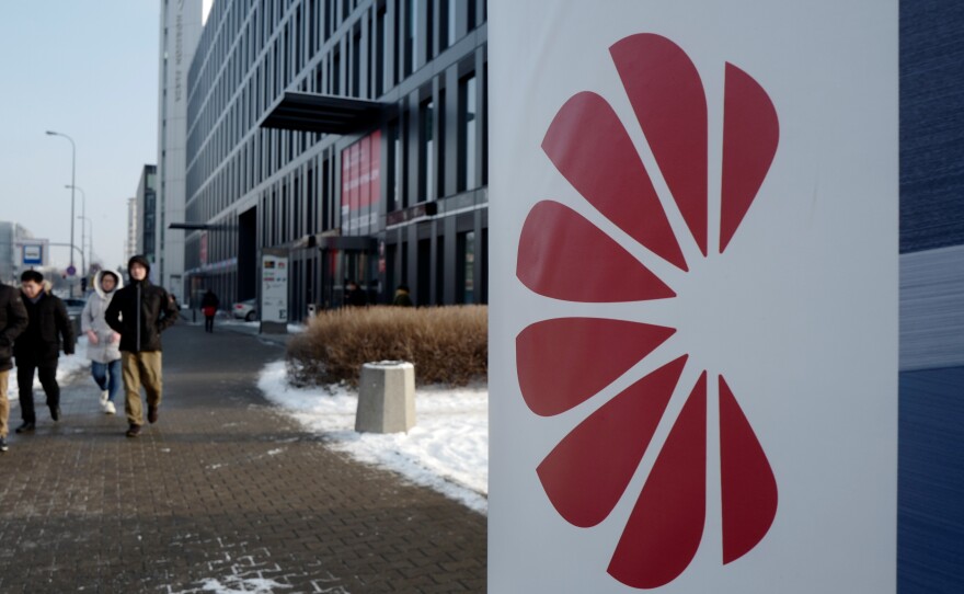 Poland's Internal Security Agency accuses Huawei's sales director in Poland of spying on behalf of China, arresting the Chinese citizen along with one other man. Here, people walk by Huawei's offices in Warsaw on Friday.