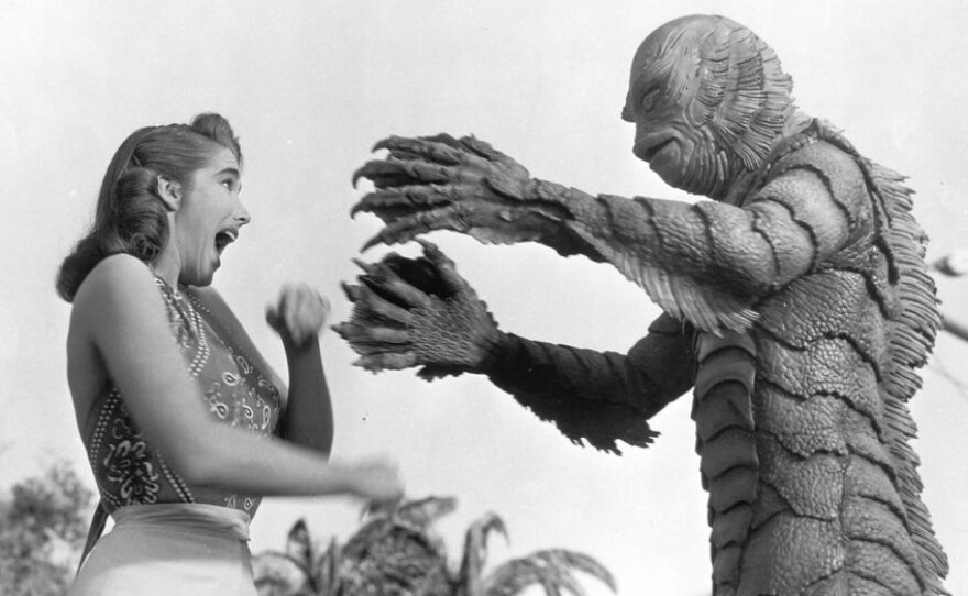 Actress Julie Adams (who died last month) reacts to the monster created by Milicent Patrick in "Creature from the Black Lagoon."