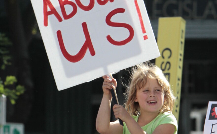 <p>In California, where deep deficits have roiled the education system, a young protester holds a sign against layoffs and other cuts during a demonstration this past May.</p>