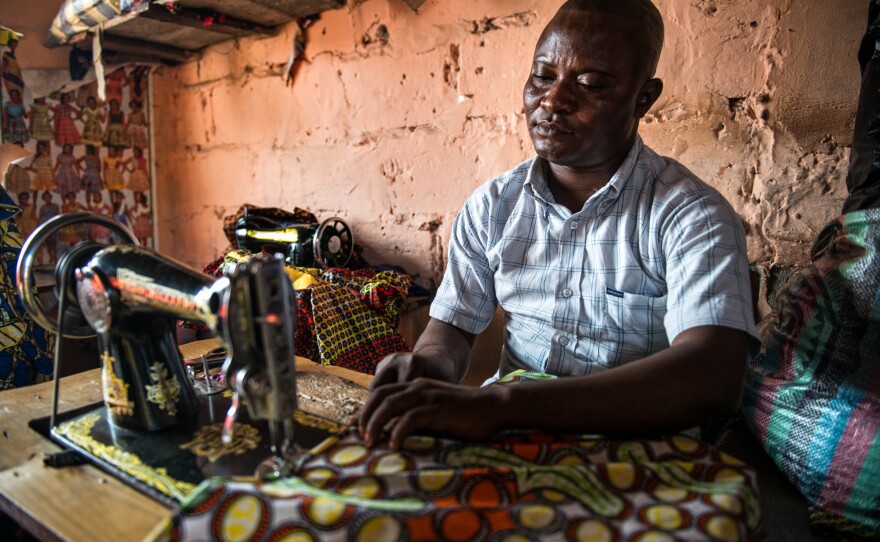 Gaby Ngabu Kasongo also has konzo. But his life has improved since he found a job as a tailor.