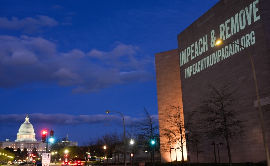 A message promoting an upcoming "No Kings" protest is projected on the National Gallery of Art, with the U.S. Capitol seen in the background, on Monday, March 23, 2026, in Washington.