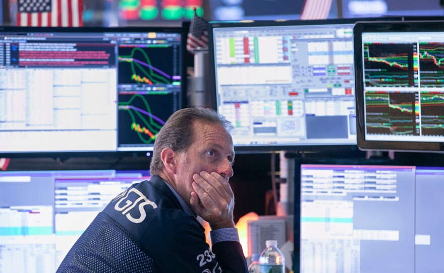 Specialist Glenn Carrel works at his post on the floor of the New York Stock Exchange, Wednesday, Aug. 14, 2019.