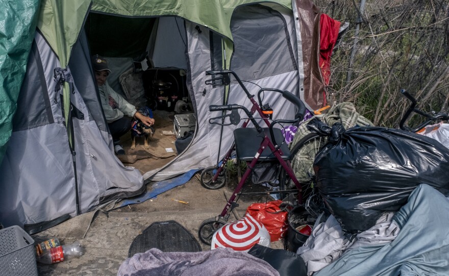 The outside of Rosie's tent has belongings strewn all around, March 8, 2023.