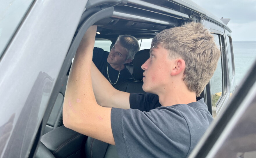 Brothers Joe and Enzo Bledsoe lock up their car ahead of cliff jumping, Aug. 5, 2026.