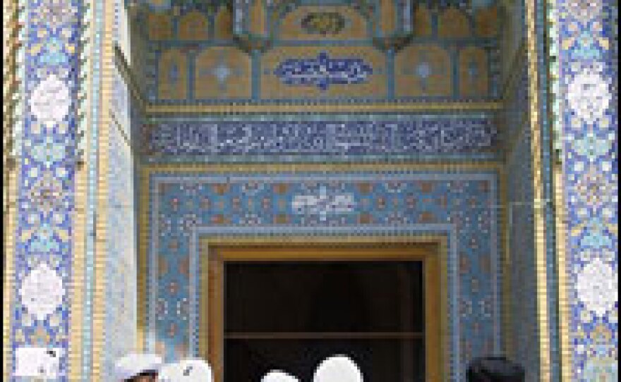 Clerics stand in the courtyard of the Azam mosque in the holy city of Qom. Like Iran's leaders, the clerics in Qom see Iran as the victim of foreign hostility, both near and far.