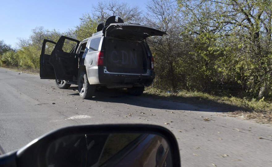 A damaged pick up marked with the initials C.D.N., that in Spanish stand for Cartel of the Northeast, is abandoned on the side of a near Villa Union, Mexico, Sunday, Dec. 1, 2019, the day after it was assaulted by gunmen.